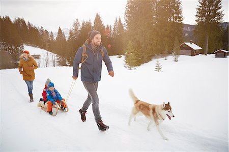 sleigh in the winter - Parents with husky pulling sons on toboggan in snow covered landscape, Elmau, Bavaria, Germany Stock Photo - Premium Royalty-Free, Code: 649-08577729