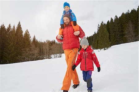 piggyback brothers - Young man shoulder carrying and walking with sons in snow covered landscape, Elmau, Bavaria, Germany Stock Photo - Premium Royalty-Free, Code: 649-08577740
