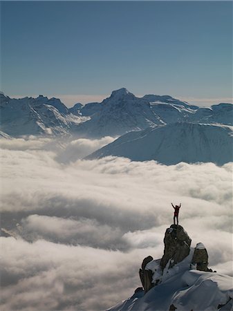 silhouette mountain peak - Climber celebrating on peak emerging from fog, Bettmeralp, Valais, Switzerland Stock Photo - Premium Royalty-Free, Code: 649-08578192