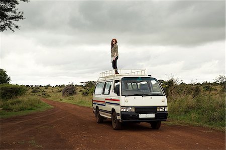 Woman standing on top of vehicle in wildlife park, Nairobi, Kenya Stock Photo - Premium Royalty-Free, Code: 649-08660892