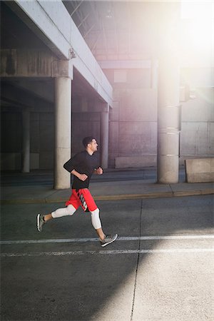 people sports in america - Young male runner running up sunlit city underpass Photographie de stock - Premium Libres de Droits, Code: 649-08660947