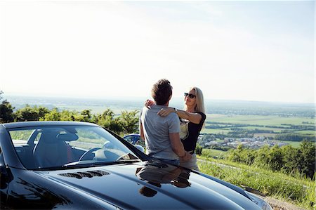 Mature couple hugging by convertible car Stock Photo - Premium Royalty-Free, Code: 649-08662171
