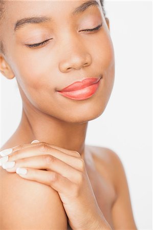 simsearch:649-07520416,k - Woman wearing lipstick, hand on shoulder, eyes closed Stock Photo - Premium Royalty-Free, Code: 649-08702522