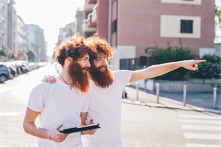 simsearch:649-08702620,k - Young male hipster twins with red hair and beards pointing on city street Stock Photo - Premium Royalty-Free, Code: 649-08702645