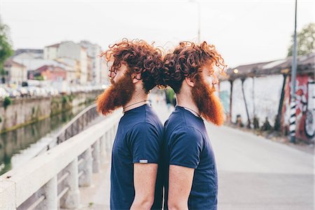 simsearch:649-08702620,k - Portrait of young male hipster twins with red hair and beards back to back on bridge Stock Photo - Premium Royalty-Free, Code: 649-08702680