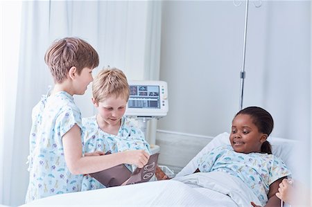 simsearch:649-07804176,k - Boy patients using blood pressure cuff on friend in bed on hospital children's ward Stock Photo - Premium Royalty-Free, Code: 649-08702714