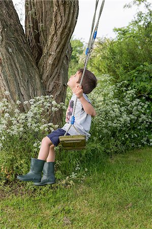 Boy on tree swing Stock Photo - Premium Royalty-Free, Code: 649-08703162