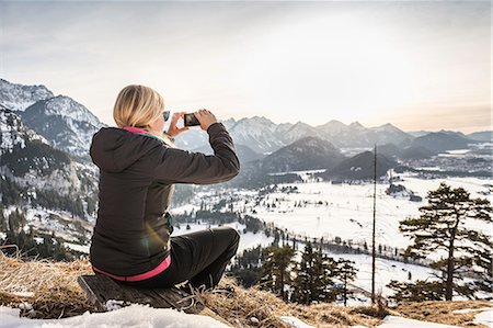 schwangau - Young female hiker photographing Allgau Alps on smartphone, Bavaria, Germany Stock Photo - Premium Royalty-Free, Code: 649-08703445