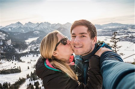 schwangau - Hiking couple taking selfie overlooking snow covered Allgau Alps, Bavaria, Germany Stock Photo - Premium Royalty-Free, Code: 649-08703446