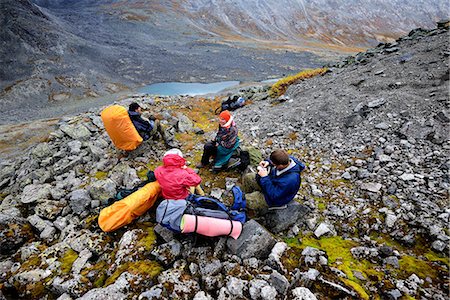 sleepy - Four adult hikers taking a break in rugged valley landscape, Khibiny mountains, Kola Peninsula, Russia Stock Photo - Premium Royalty-Free, Code: 649-08703480