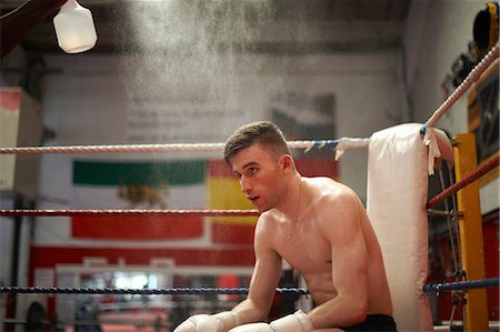 Boxer sitting in corner of boxing ring, exhausted Photographie de stock - Premium Libres de Droits, Code: 649-08714043