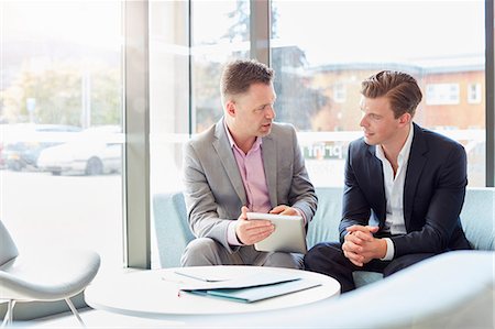 Two  businessmen using digital table at office meeting Stock Photo - Premium Royalty-Free, Code: 649-08714132