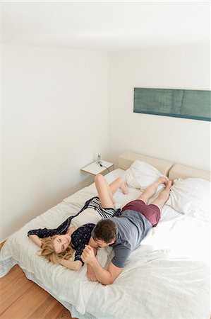 Couple lying on bed talking Stock Photo - Premium Royalty-Free, Code: 649-08714460