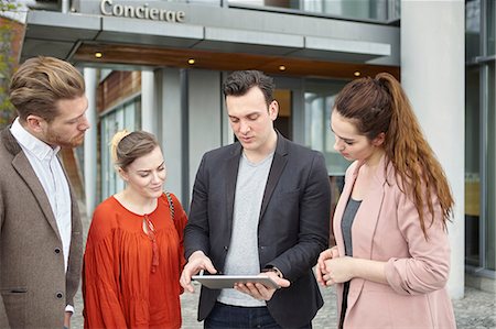 simsearch:649-07560130,k - Businesswomen and businessmen looking at digital tablet outside office, London, UK Stock Photo - Premium Royalty-Free, Code: 649-08714624