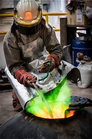 foundry worker - Male foundry worker taking temperature of furnace in bronze foundry Stock Photo - Premium Royalty-Free, Code: 649-08715043