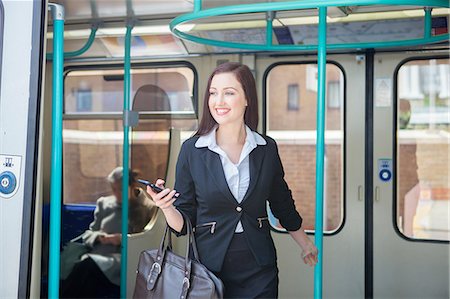 people smiling london - Businesswoman travelling in Docklands Light Railway train, London Stock Photo - Premium Royalty-Free, Code: 649-08744831