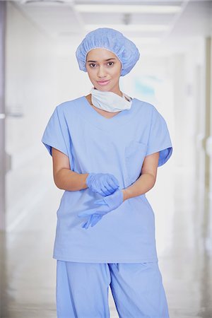 Portrait of mid adult female medic wearing scrubs in hospital corridor Stock Photo - Premium Royalty-Free, Code: 649-08745372