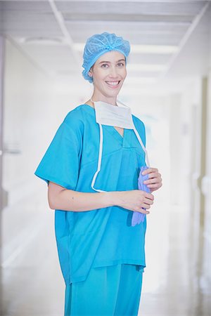Portrait of young female medic wearing scrubs in hospital corridor Stock Photo - Premium Royalty-Free, Code: 649-08745373