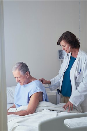 simsearch:6113-06908281,k - Female doctor listening to senior male patient back with stethoscope Stock Photo - Premium Royalty-Free, Code: 649-08745405