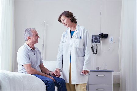 simsearch:700-02121243,k - Female doctors explaining to senior male patient on hospital bed Stock Photo - Premium Royalty-Free, Code: 649-08745406