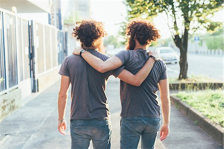 simsearch:649-08702620,k - Rear view of identical male adult twins strolling on sidewalk Stock Photo - Premium Royalty-Free, Code: 649-08765962