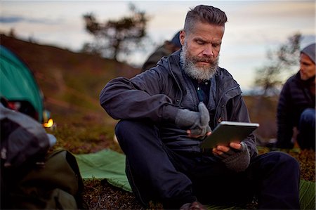 simsearch:614-08119553,k - Hiker using digital tablet by tent, Keimiotunturi, Lapland, Finland Stock Photo - Premium Royalty-Free, Code: 649-08766390