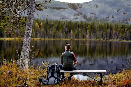 simsearch:614-05557077,k - Hiker resting on bench, looking out at lake, Kesankijarvi, Lapland, Finland Stock Photo - Premium Royalty-Free, Code: 649-08766393