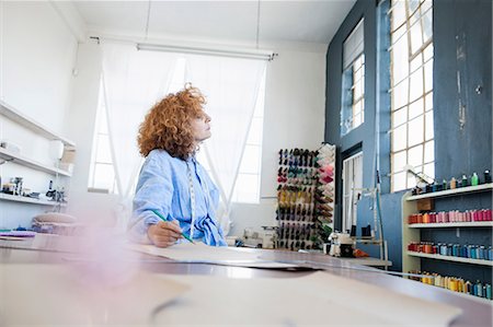 simsearch:614-06896117,k - Fashion designer at desk in workshop looking away Stock Photo - Premium Royalty-Free, Code: 649-08824576