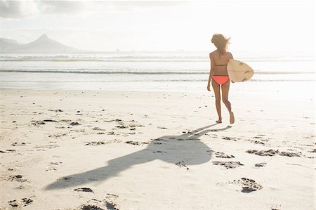 simsearch:649-07585546,k - Young female surfer on sunlit beach, Cape Town, Western Cape, South Africa Stock Photo - Premium Royalty-Free, Code: 649-08824630