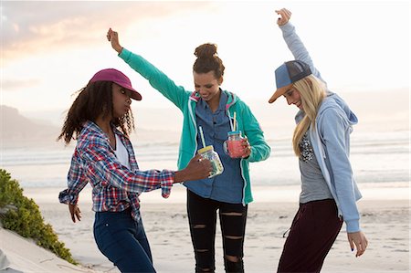 simsearch:649-07736862,k - Three young female friends dancing together on beach, Cape Town, Western Cape, South Africa Stock Photo - Premium Royalty-Free, Code: 649-08824641