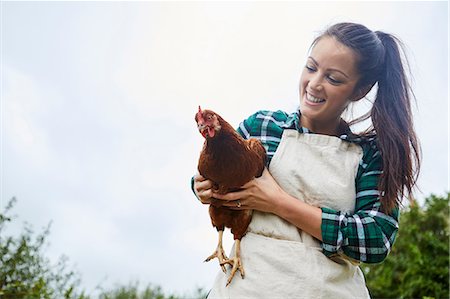 simsearch:649-07560533,k - Woman holding chicken Photographie de stock - Premium Libres de Droits, Code: 649-08824751