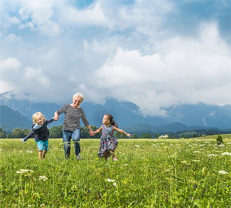 simsearch:649-07596731,k - Grandmother and grandchildren running in field holding hands, Fuessen, Bavaria, Germany Stock Photo - Premium Royalty-Free, Code: 649-08824944