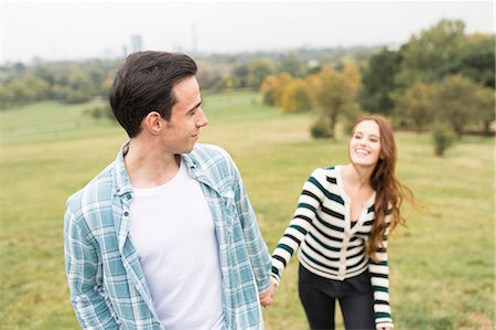 simsearch:649-08239088,k - Couple in field holding hands Stock Photo - Premium Royalty-Free, Code: 649-08825054