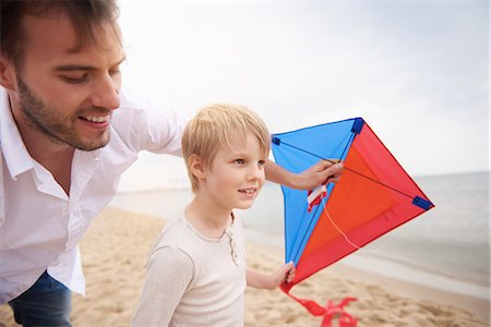 Father and son playing kite on beach Stock Photo - Premium Royalty-Free, Code: 649-08825072