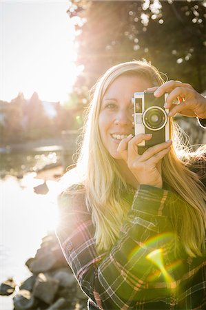 Portrait of woman taking photographs on waterfront at Granville Island, Vancouver, Canada Stock Photo - Premium Royalty-Free, Code: 649-08825220