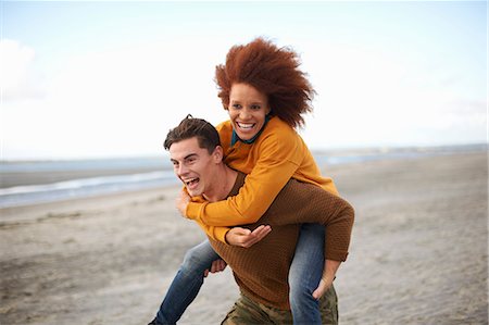 simsearch:614-07194495,k - Couple playing piggyback on beach Stock Photo - Premium Royalty-Free, Code: 649-08840020