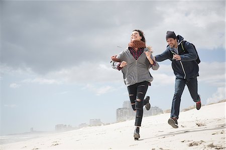 Young couple running and chasing on beach, Western Cape, South Africa Stock Photo - Premium Royalty-Free, Code: 649-08840207