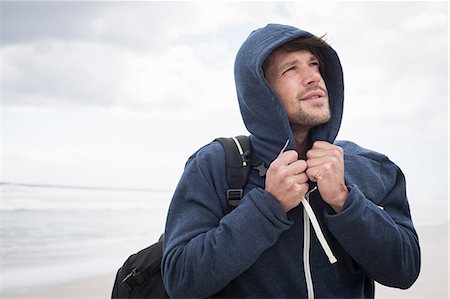 Young man wearing hoody on beach, Western Cape, South Africa Stock Photo - Premium Royalty-Free, Code: 649-08840201