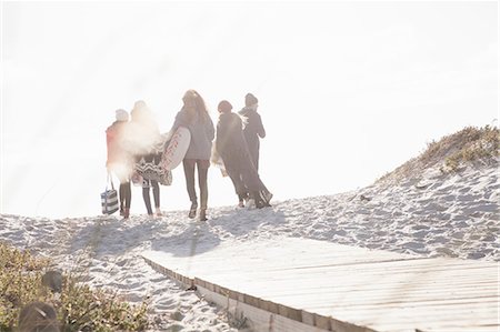 simsearch:649-07279678,k - Rear view of young adult friends strolling on sunlit boardwalk at beach, Western Cape, South Africa Stock Photo - Premium Royalty-Free, Code: 649-08840228