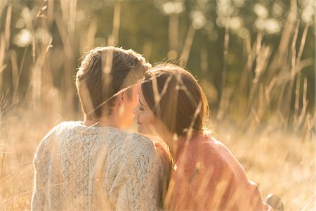 simsearch:649-08239088,k - Young couple sitting in rural setting, kissing Stock Photo - Premium Royalty-Free, Code: 649-08840574