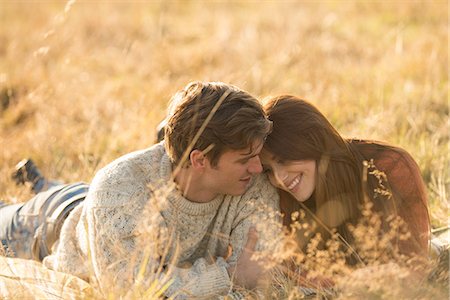 simsearch:649-08239088,k - Young couple lying in field, smiling Stock Photo - Premium Royalty-Free, Code: 649-08840571