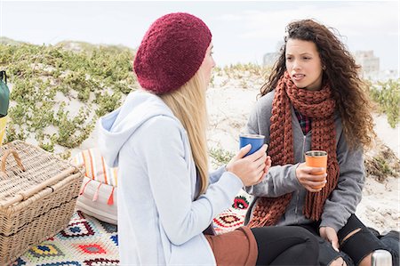 Two young women chatting beach picnic, Western Cape, South Africa Stock Photo - Premium Royalty-Free, Code: 649-08840651