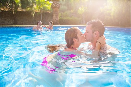 swimming pool villa - Couple in swimming pool kissing Stock Photo - Premium Royalty-Free, Code: 649-08859498