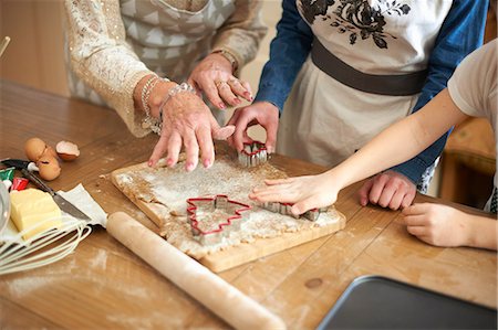 simsearch:649-07761247,k - Cropped shot of senior woman and granddaughters cutting Christmas tree cookies at kitchen counter Stock Photo - Premium Royalty-Free, Code: 649-08860518