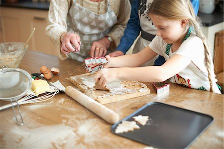 simsearch:649-07761247,k - Cropped shot of senior woman and granddaughters cutting Christmas tree cookies at kitchen counter Stock Photo - Premium Royalty-Free, Code: 649-08860519