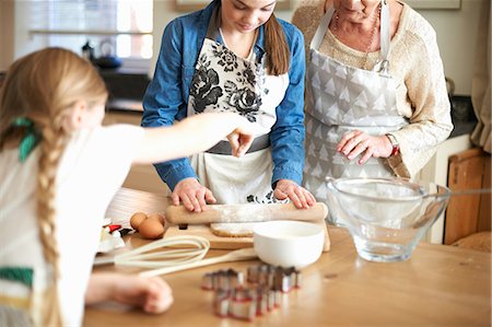 simsearch:614-08270379,k - Senior woman and granddaughters rolling dough for Christmas tree cookies Stock Photo - Premium Royalty-Free, Code: 649-08860512