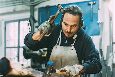 simsearch:649-07710266,k - Male metalworker hammering metal in forge workshop Stock Photo - Premium Royalty-Free, Code: 649-08894126