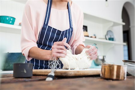 simsearch:649-06845217,k - Cropped shot of young woman stretching dough at kitchen counter Stock Photo - Premium Royalty-Free, Code: 649-08894275