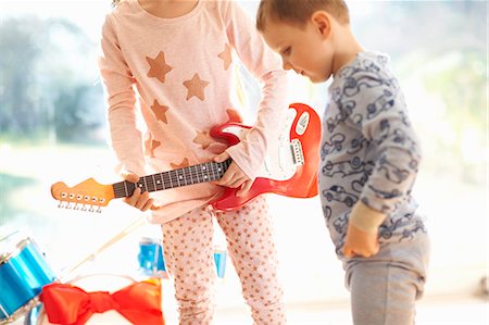 pyjama - Girl and brother playing with toy guitar on christmas day Stock Photo - Premium Royalty-Free, Code: 649-08894376