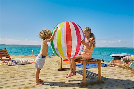 preteen boys playing - Boy and girl playing with beach ball on houseboat sun deck, Kraalbaai, South Africa Stock Photo - Premium Royalty-Free, Code: 649-08894481